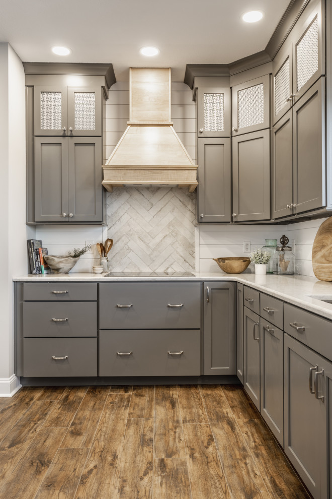 Inspiration for a large traditional l-shaped kitchen/diner in Indianapolis with a submerged sink, shaker cabinets, grey cabinets, engineered stone countertops, white splashback, tonge and groove splashback, stainless steel appliances, vinyl flooring, no island and brown floors.