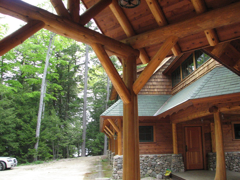 Inspiration for a large rustic brown two-story wood exterior home remodel with a shed roof