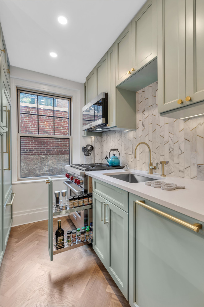 Eat-in kitchen - mid-sized transitional galley medium tone wood floor eat-in kitchen idea in New York with a drop-in sink, beaded inset cabinets, green cabinets, quartz countertops, multicolored backsplash, marble backsplash, stainless steel appliances, an island and white countertops