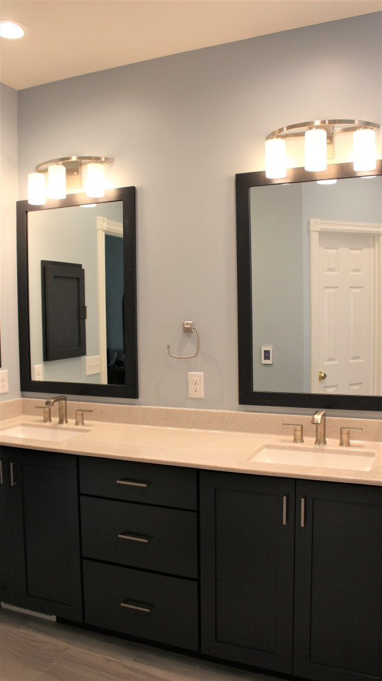Master bathroom in Other with shaker cabinets, blue cabinets, blue walls, ceramic floors, an undermount sink, onyx benchtops, grey floor, beige benchtops, an enclosed toilet, a double vanity and a built-in vanity.