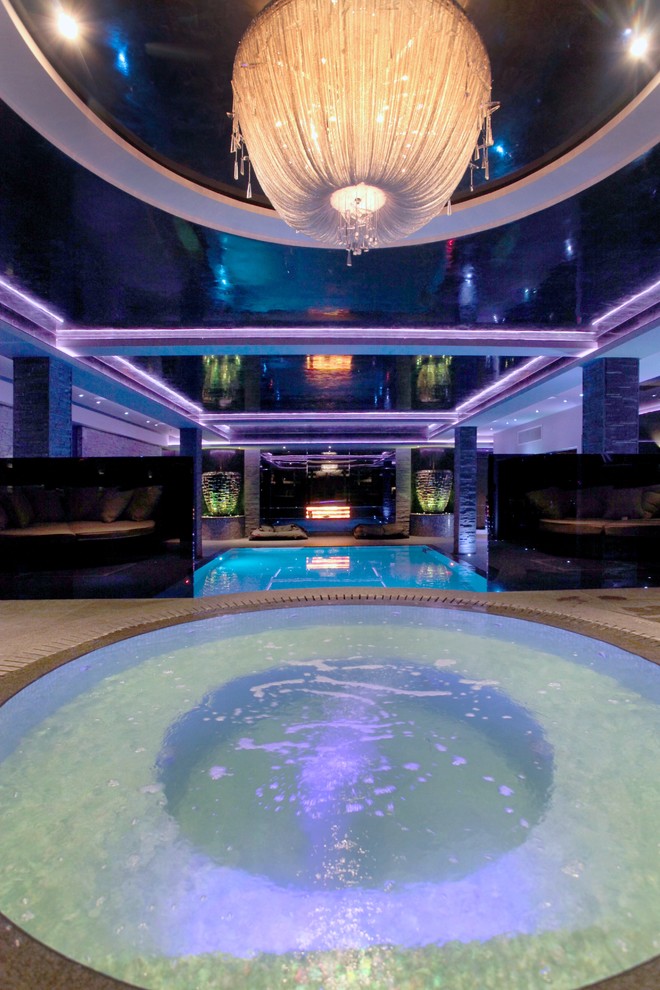 Inspiration for an expansive modern indoor round pool in Cheshire with a hot tub.