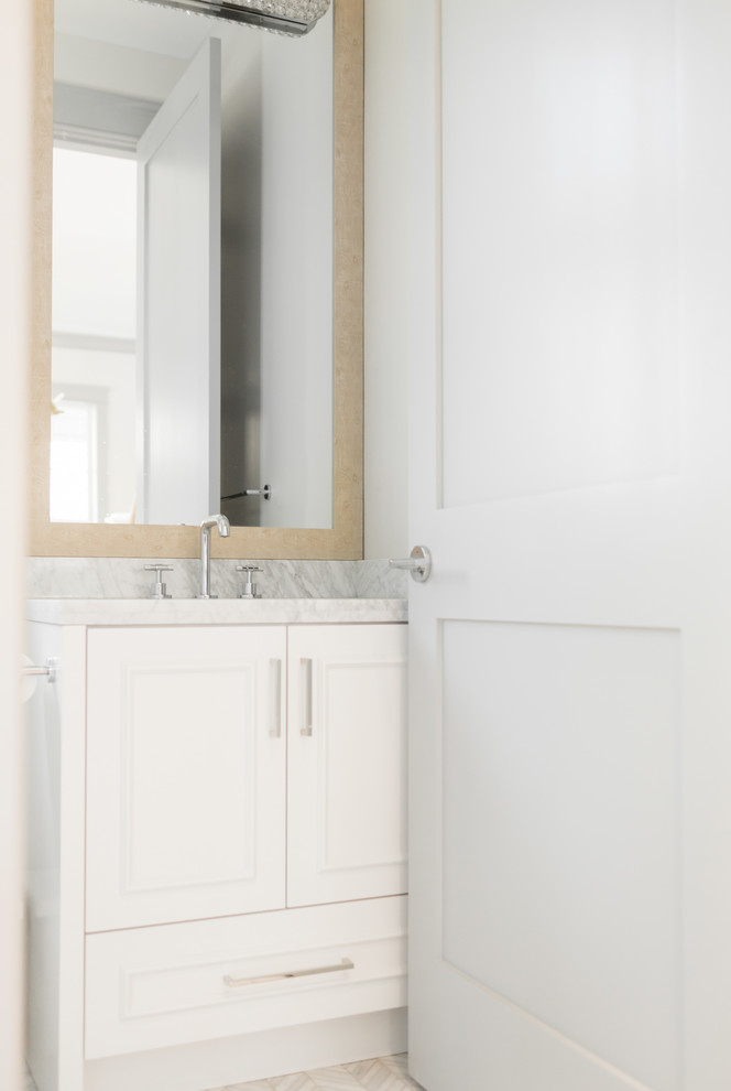 Design ideas for a small transitional bathroom in Vancouver with flat-panel cabinets, white cabinets, a drop-in tub, a corner shower, a one-piece toilet, white tile, marble, white walls, marble floors, a drop-in sink, marble benchtops, white floor and a hinged shower door.