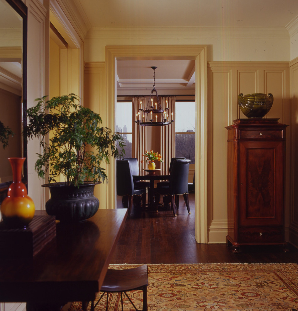 Inspiration for a traditional hallway in New York with beige walls and dark hardwood floors.