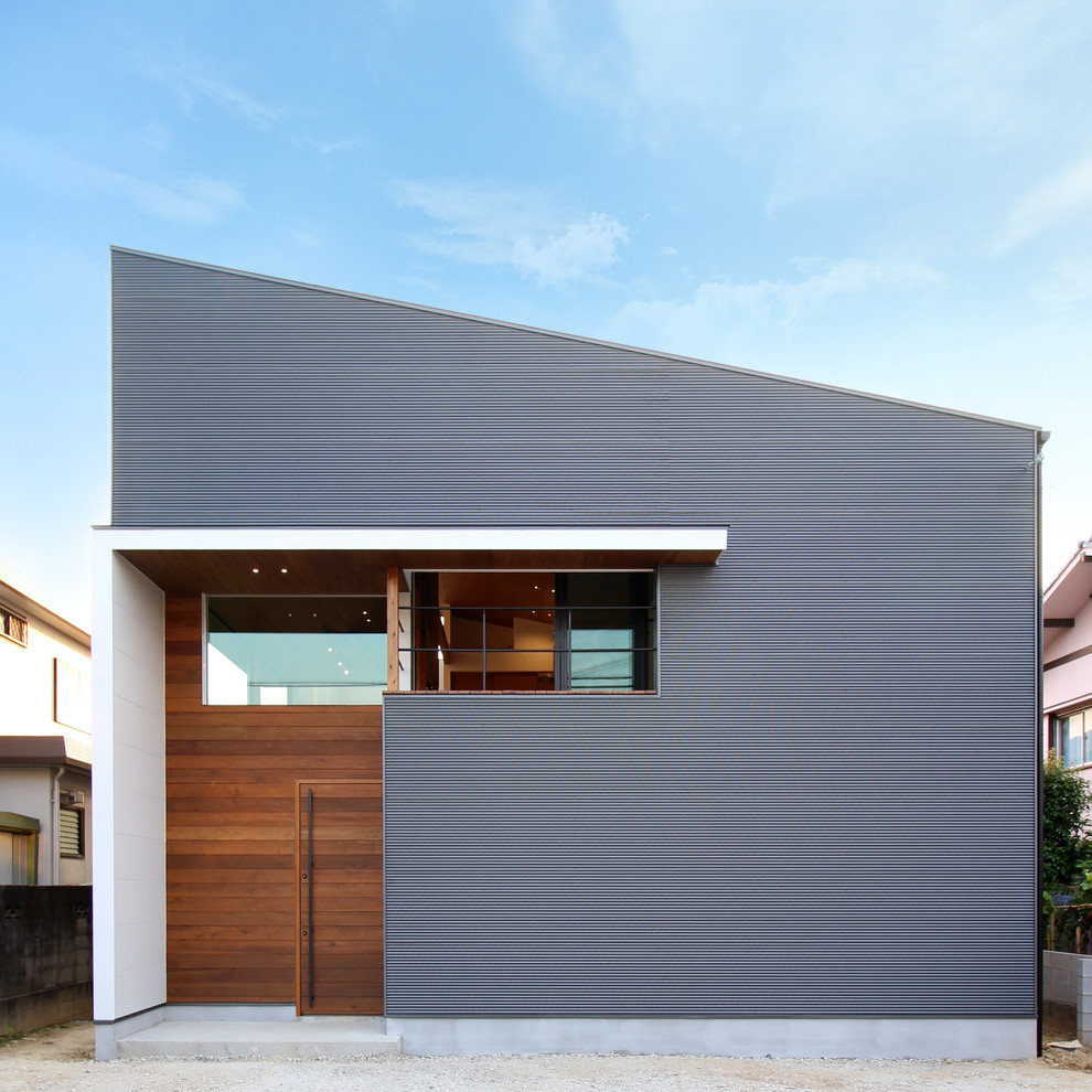 This is an example of a contemporary grey exterior in Other with a shed roof.