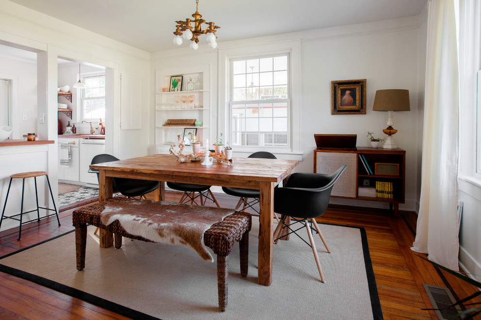 Inspiration for a farmhouse medium tone wood floor and brown floor enclosed dining room remodel in Charleston with white walls