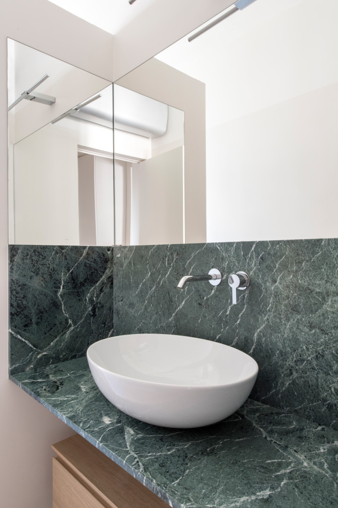 Inspiration for a mid-sized contemporary 3/4 green tile and matchstick tile light wood floor, beige floor and single-sink bathroom remodel in Milan with flat-panel cabinets, light wood cabinets, a wall-mount toilet, white walls, a vessel sink, marble countertops, green countertops and a floating vanity