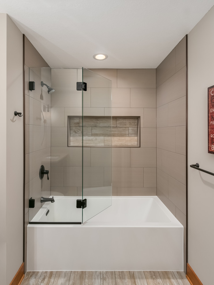 Photo of a mid-sized beach style master bathroom in Minneapolis with flat-panel cabinets, grey cabinets, a drop-in tub, a shower/bathtub combo, a one-piece toilet, beige tile, ceramic tile, beige walls, laminate floors, a drop-in sink, marble benchtops, beige floor, a hinged shower door, multi-coloured benchtops, a single vanity and a floating vanity.