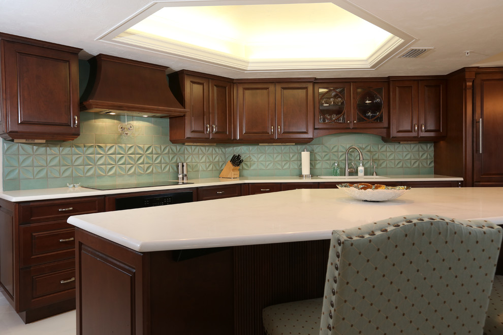 Design ideas for a large tropical l-shaped eat-in kitchen in Orlando with an undermount sink, raised-panel cabinets, dark wood cabinets, quartz benchtops, blue splashback, terra-cotta splashback, panelled appliances, porcelain floors and with island.