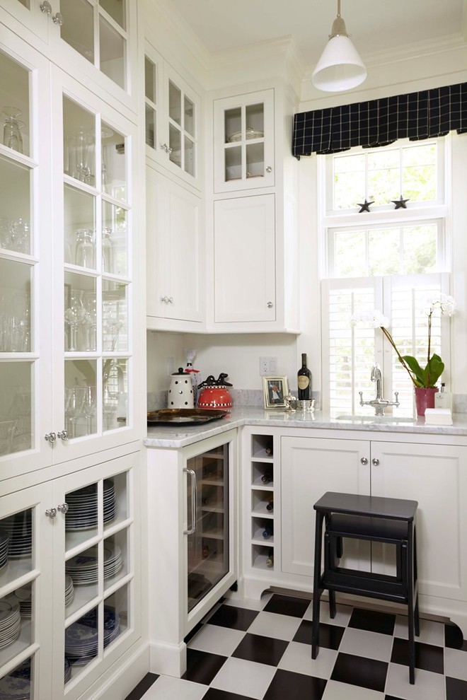 Design ideas for a mid-sized traditional u-shaped kitchen pantry in Portland Maine with glass-front cabinets, white cabinets, an undermount sink, stainless steel appliances, ceramic floors, no island, multi-coloured floor and white benchtop.