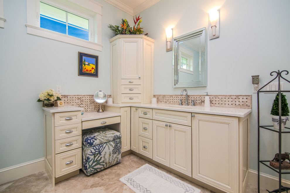 This is an example of a mid-sized beach style master bathroom in Miami with recessed-panel cabinets, white cabinets, an open shower, a one-piece toilet, blue walls, linoleum floors, an undermount sink and engineered quartz benchtops.