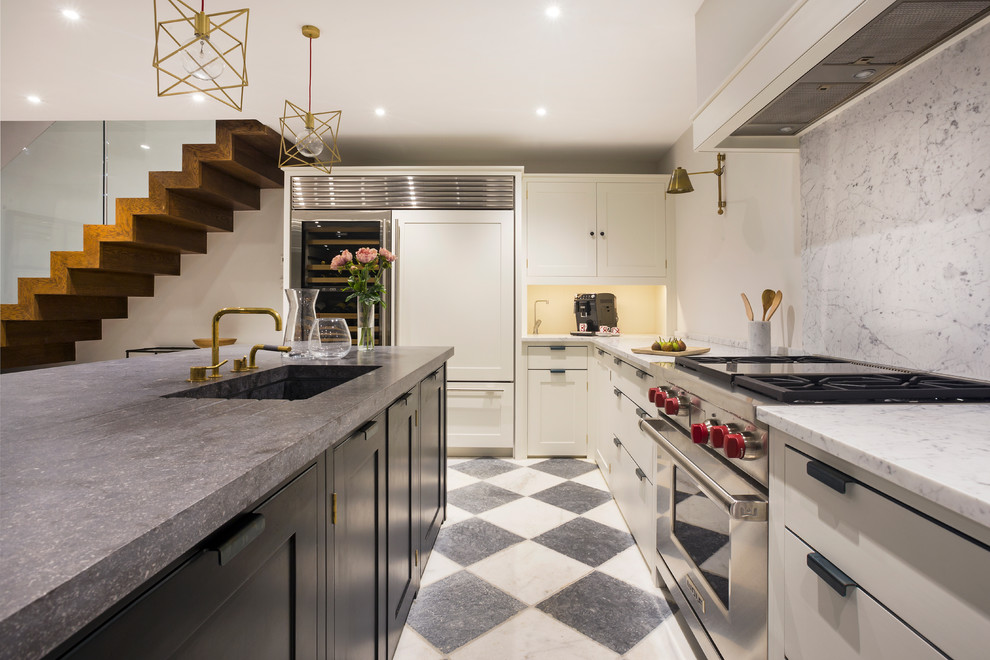 Design ideas for a mid-sized contemporary galley eat-in kitchen in London with an undermount sink, recessed-panel cabinets, white cabinets, marble benchtops, white splashback, stone slab splashback, stainless steel appliances, marble floors and with island.
