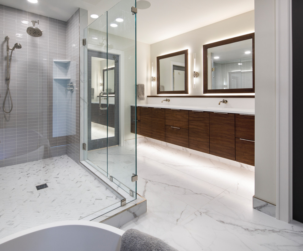 Photo of a mid-sized modern master bathroom in Minneapolis with flat-panel cabinets, brown cabinets, a freestanding tub, a corner shower, a drop-in sink, engineered quartz benchtops, a hinged shower door, white benchtops, a laundry, a double vanity and a floating vanity.