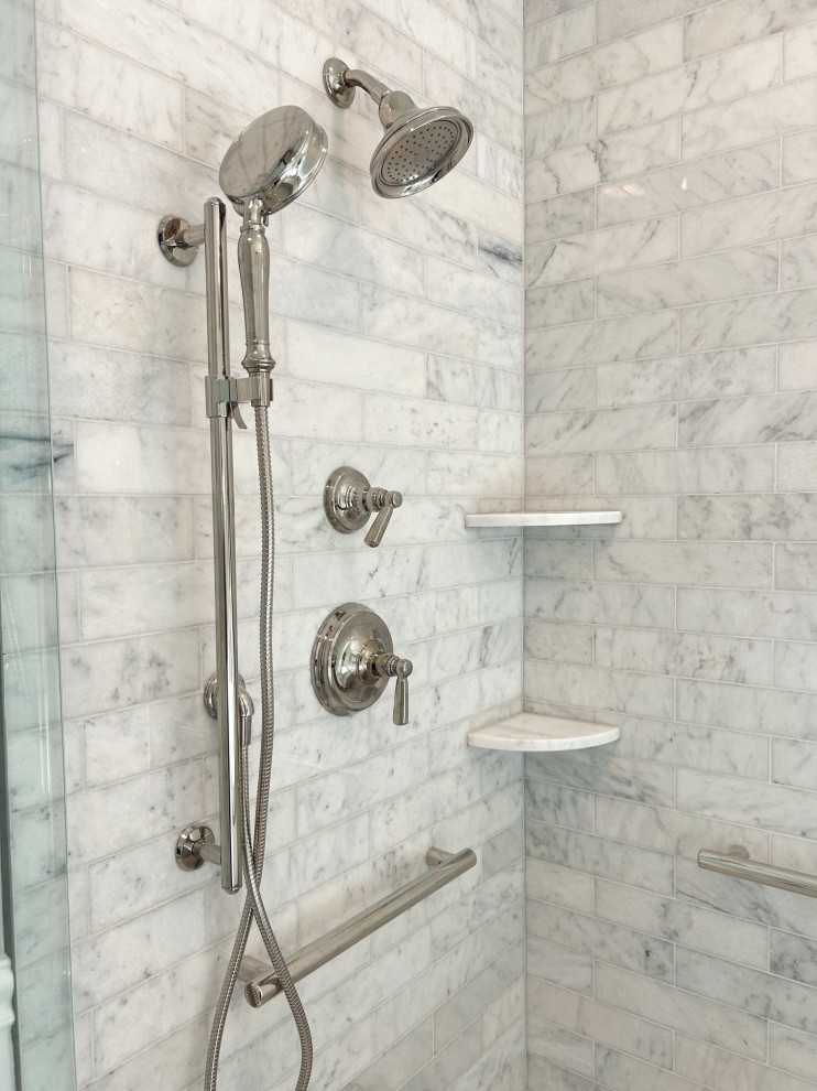 Example of a mid-sized transitional master gray tile and marble tile marble floor, gray floor, double-sink and wainscoting freestanding bathtub design with shaker cabinets, white cabinets, a two-piece toilet, blue walls, an undermount sink, quartz countertops, a hinged shower door, gray countertops and a built-in vanity
