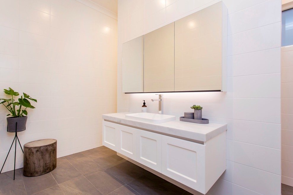 Design ideas for a large traditional kids bathroom in Adelaide with a freestanding tub, a double shower, white tile, white walls, porcelain floors, grey floor, an open shower, beaded inset cabinets, white cabinets, porcelain tile, an integrated sink and marble benchtops.
