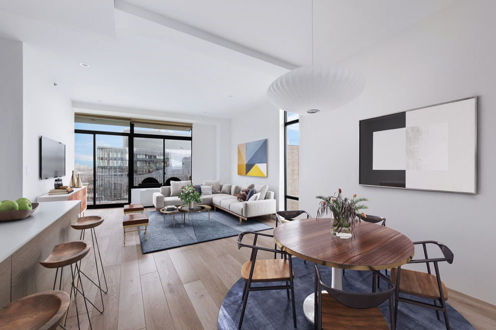 Family room - mid-sized contemporary open concept light wood floor and brown floor family room idea in New York with white walls, no fireplace and a wall-mounted tv