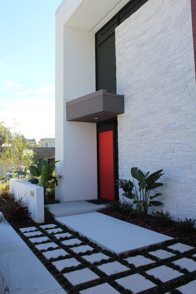 Large modern two-storey white exterior in Tampa with mixed siding and a flat roof.
