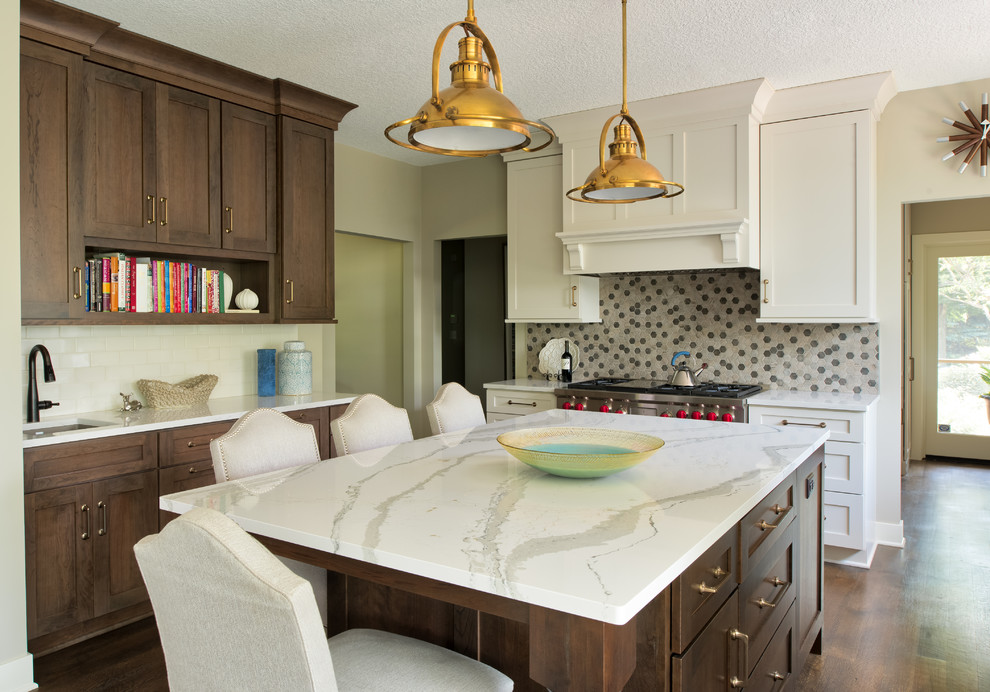 Large transitional u-shaped dark wood floor and brown floor enclosed kitchen photo in Minneapolis with a single-bowl sink, shaker cabinets, dark wood cabinets, marble countertops, beige backsplash, ceramic backsplash, stainless steel appliances and an island