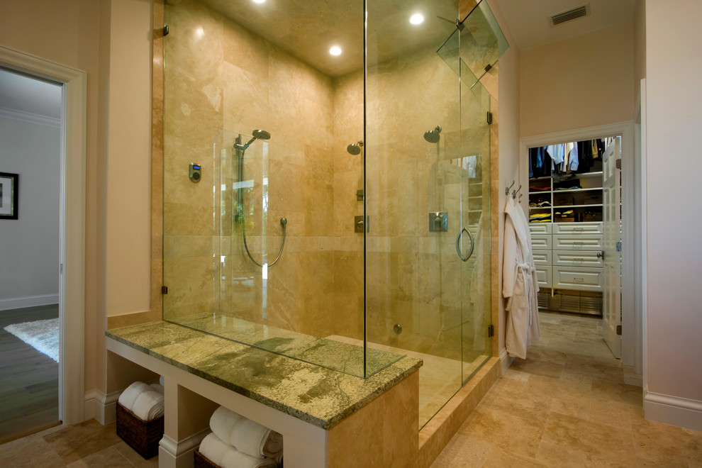 This is an example of a large transitional master bathroom in Tampa with shaker cabinets, dark wood cabinets, a freestanding tub, a corner shower, beige tile, ceramic tile, beige walls, ceramic floors, an undermount sink, glass benchtops, beige floor, a hinged shower door and green benchtops.