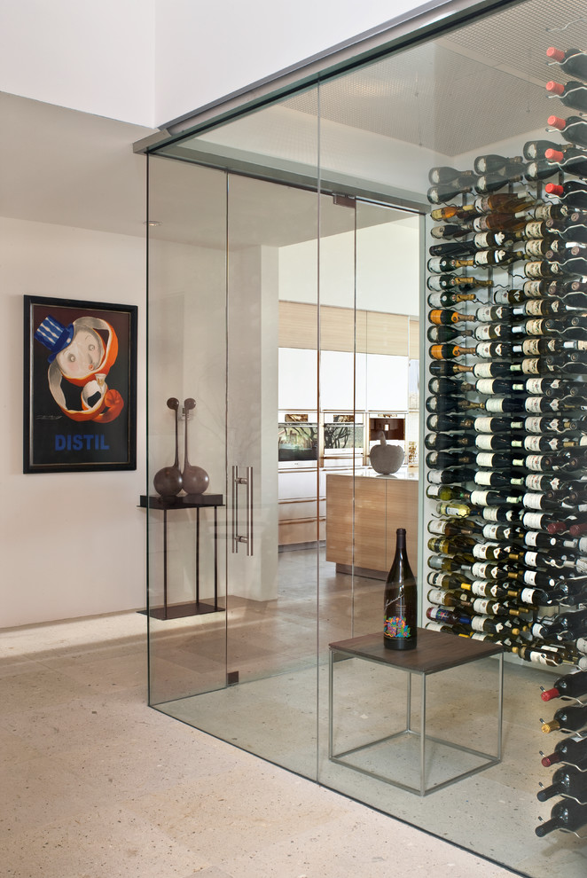 Photo of an expansive modern wine cellar in Phoenix with display racks and grey floor.