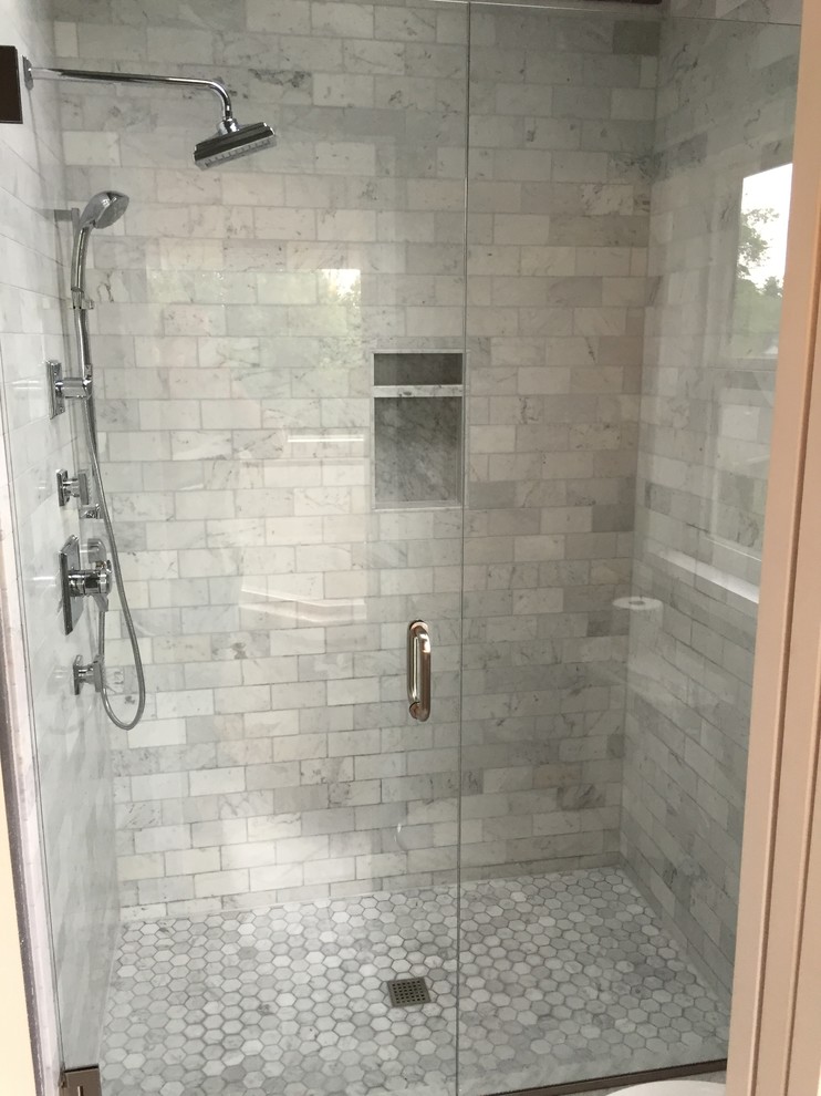 Photo of a large contemporary master bathroom in Portland with furniture-like cabinets, light wood cabinets, a corner tub, an alcove shower, gray tile, ceramic tile, grey walls and marble floors.