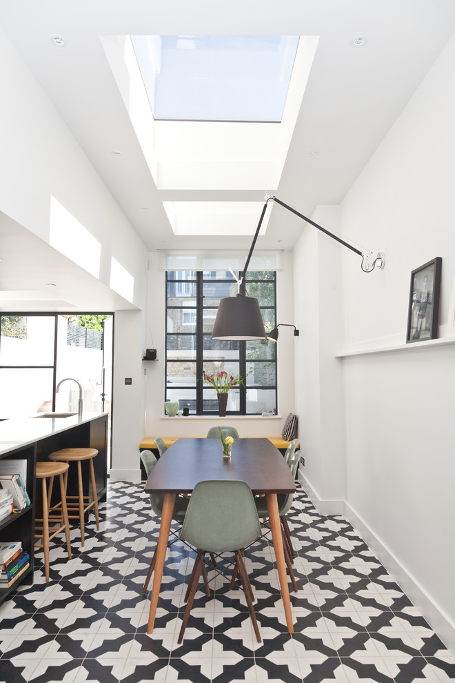 Inspiration for a transitional kitchen/dining combo in London with white walls.