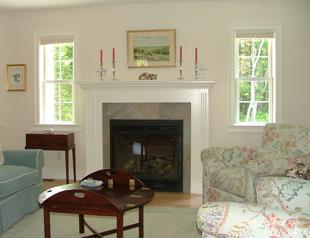 Design ideas for a mid-sized traditional open concept family room in Portland Maine with medium hardwood floors, a standard fireplace, a stone fireplace surround and no tv.