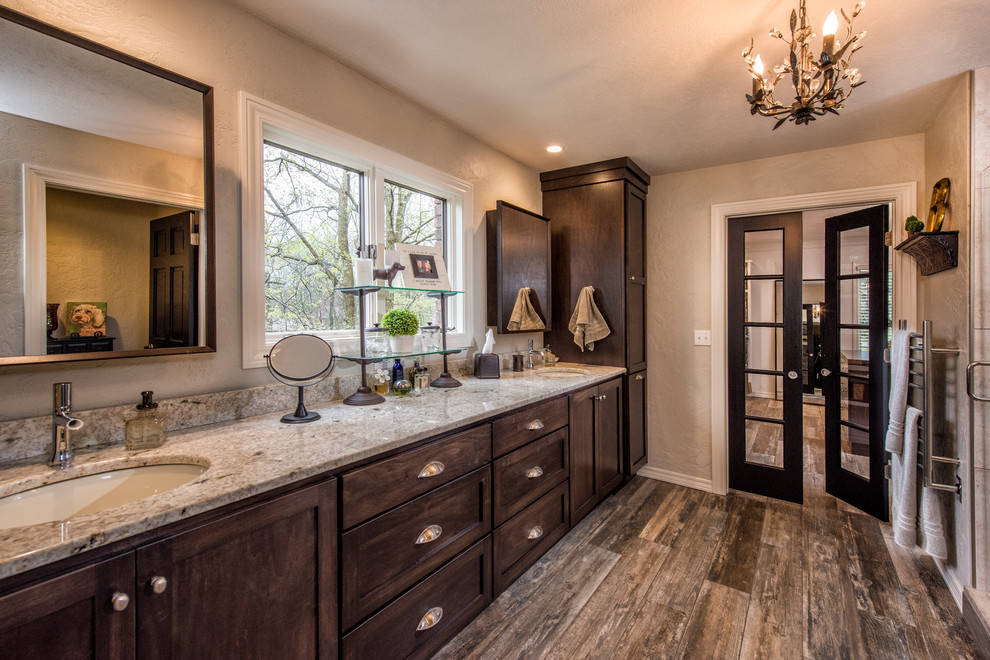 Small transitional master dark wood floor bathroom photo with recessed-panel cabinets, medium tone wood cabinets, granite countertops, beige walls and an undermount sink
