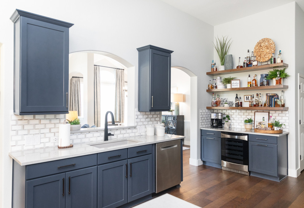 Mountain style kitchen photo in Austin with blue cabinets, mosaic tile backsplash, stainless steel appliances and no island