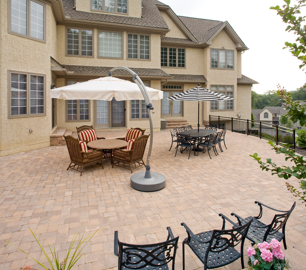Design ideas for a mid-sized traditional backyard patio in Philadelphia with concrete pavers.