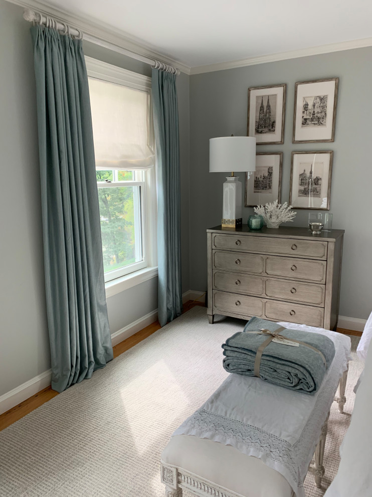 Mid-sized transitional guest medium tone wood floor and brown floor bedroom photo in Boston with gray walls and no fireplace
