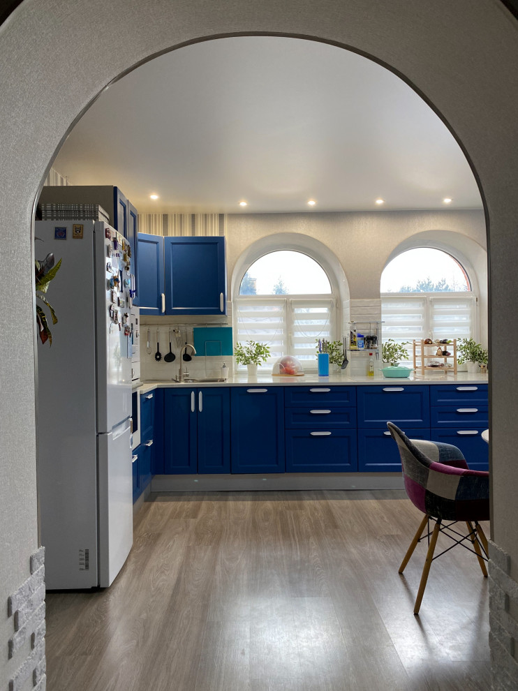 Medium sized traditional kitchen/diner in Moscow with blue cabinets, quartz worktops, white splashback, no island, brown floors and white worktops.