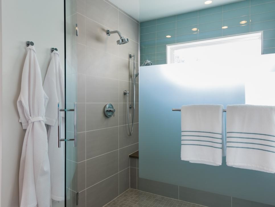 Inspiration for a large modern master bathroom in Boston with flat-panel cabinets, brown cabinets, a corner shower, blue tile, white walls, linoleum floors, a drop-in sink, marble benchtops, white floor, a hinged shower door and white benchtops.
