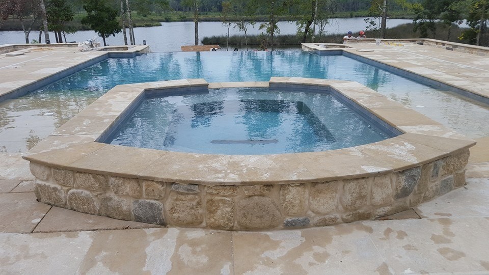 Inspiration for a mid-sized transitional backyard stone and rectangular natural hot tub remodel in Miami