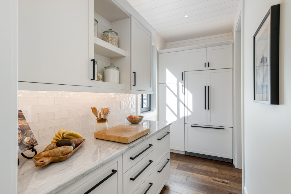 Inspiration for a rustic brown floor, wood ceiling and dark wood floor kitchen pantry remodel with shaker cabinets, white cabinets, quartzite countertops, white backsplash, stone slab backsplash, stainless steel appliances, an island and white countertops