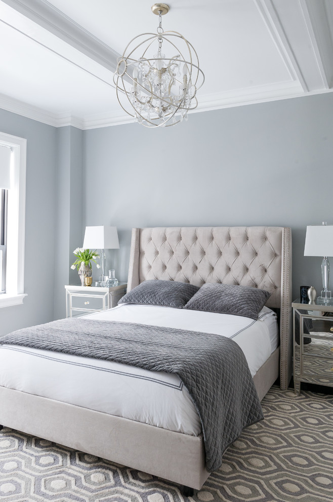 This is an example of a transitional bedroom in New York with grey walls and grey floor.