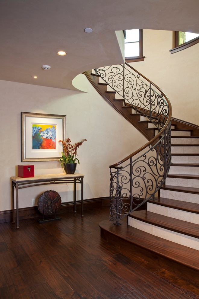 Photo of a mediterranean wood staircase in San Francisco with travertine risers and mixed railing.