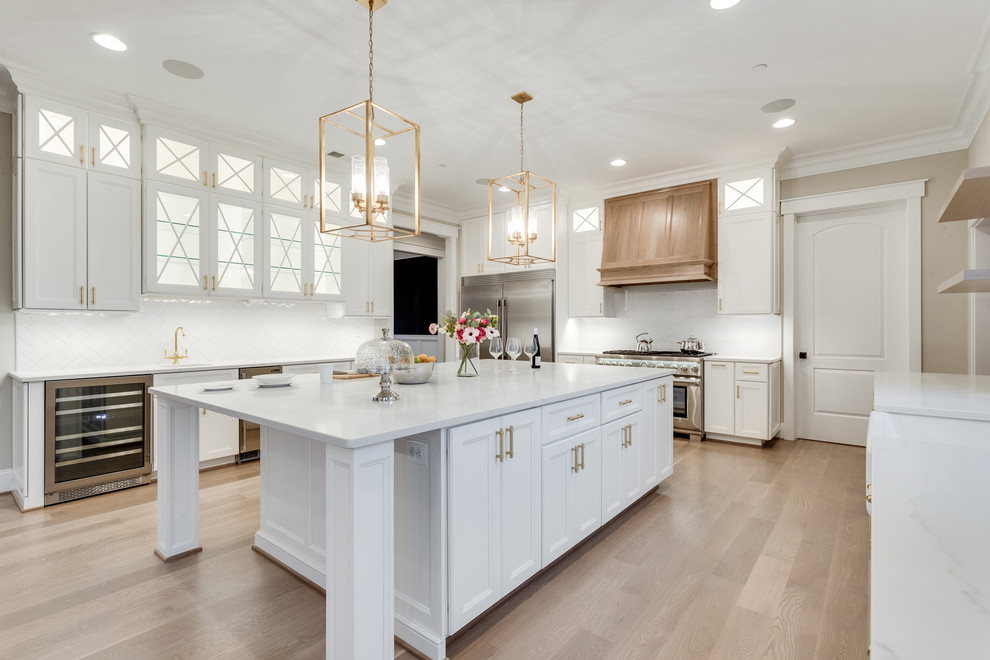 Inspiration for a huge transitional kitchen remodel in Baltimore with flat-panel cabinets, white cabinets, marble countertops, white backsplash, subway tile backsplash, stainless steel appliances and an island