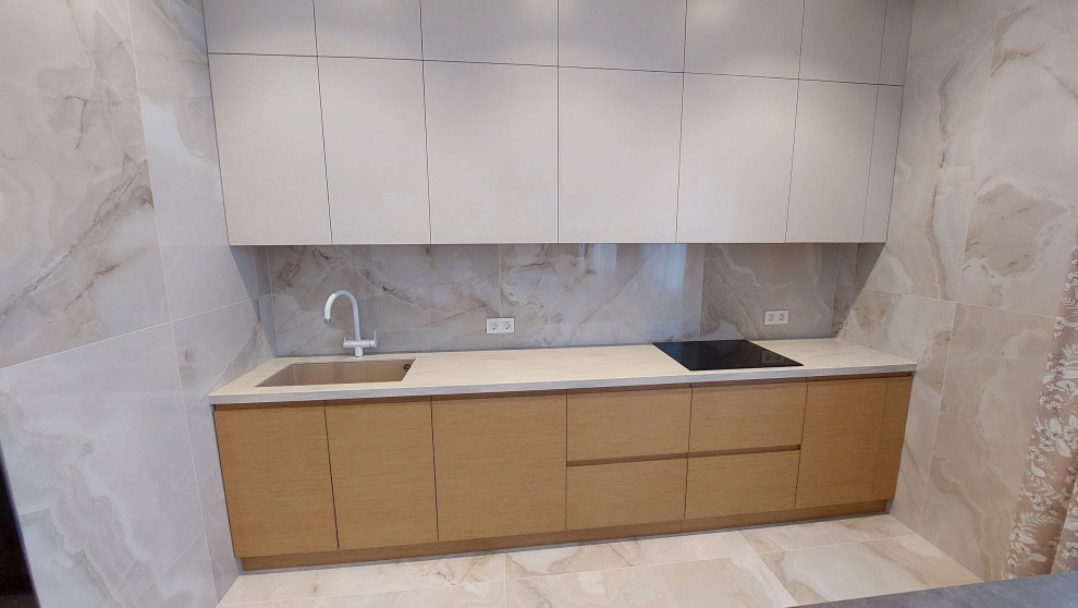 Photo of a mid-sized modern single-wall kitchen in Other with beige splashback, porcelain splashback and beige benchtop.