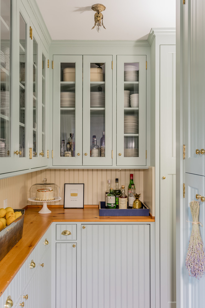 Eat-in kitchen - transitional l-shaped light wood floor and beige floor eat-in kitchen idea in Boston with an undermount sink, wood countertops, white backsplash, stainless steel appliances, an island, beaded inset cabinets, blue cabinets, wood backsplash and brown countertops