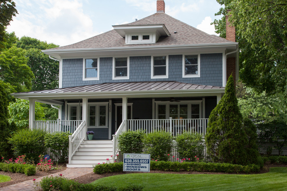Mid-sized traditional two-storey blue house exterior in Chicago with concrete fiberboard siding, a gable roof and a mixed roof.