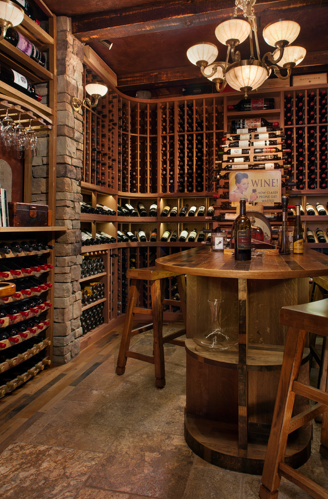 Design ideas for a mid-sized country wine cellar in Phoenix with storage racks, beige floor and slate floors.