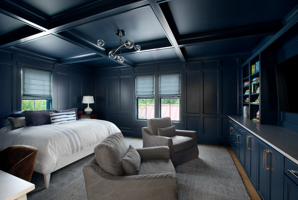 This is an example of a contemporary bedroom in Charleston with blue walls and light hardwood floors.