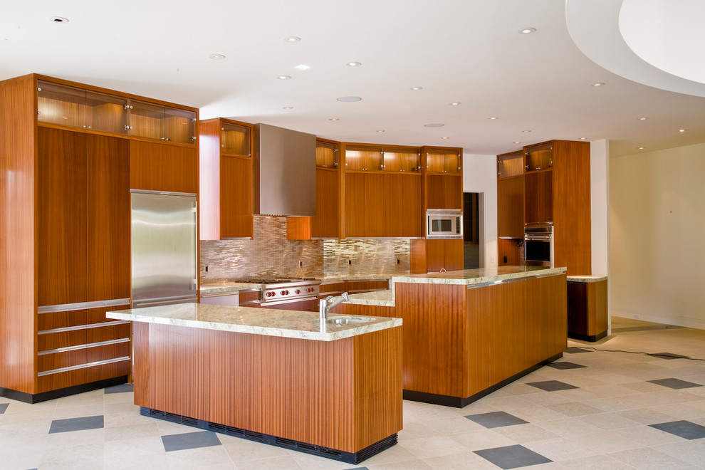 Photo of a large contemporary galley eat-in kitchen in Salt Lake City with an undermount sink, flat-panel cabinets, medium wood cabinets, limestone benchtops, metallic splashback, metal splashback, stainless steel appliances, travertine floors, with island and beige floor.