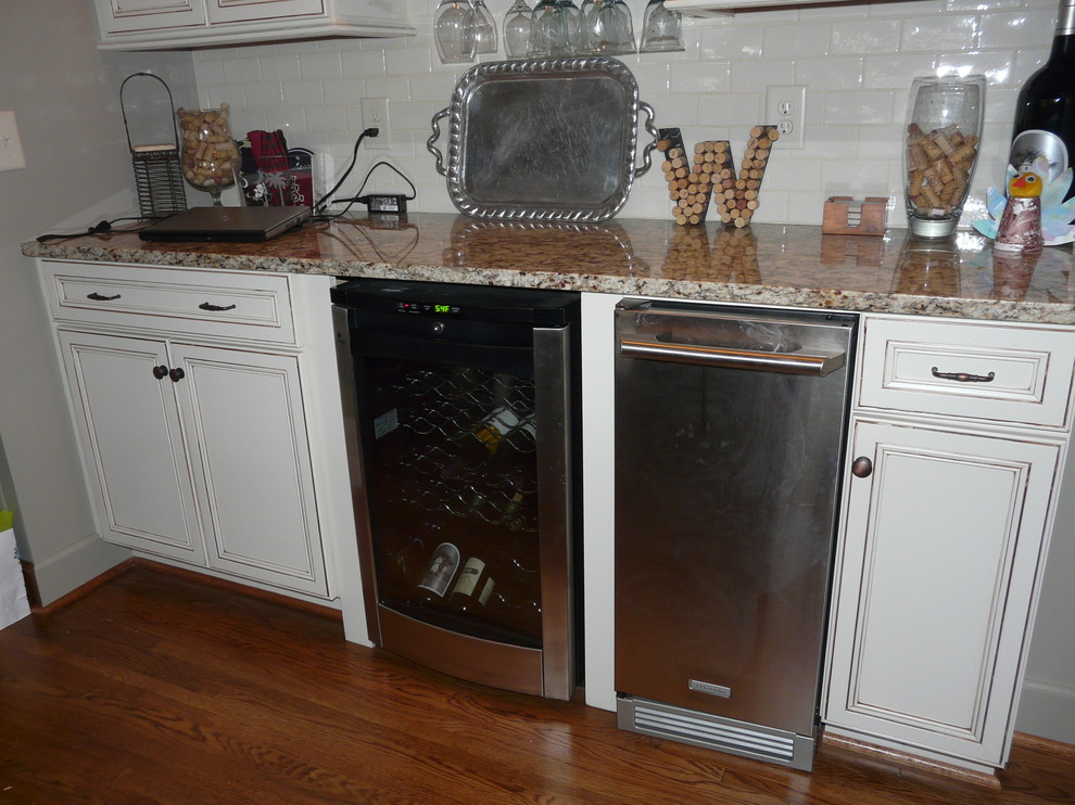 Transitional eat-in kitchen photo in Birmingham with a farmhouse sink, flat-panel cabinets, granite countertops, porcelain backsplash and stainless steel appliances