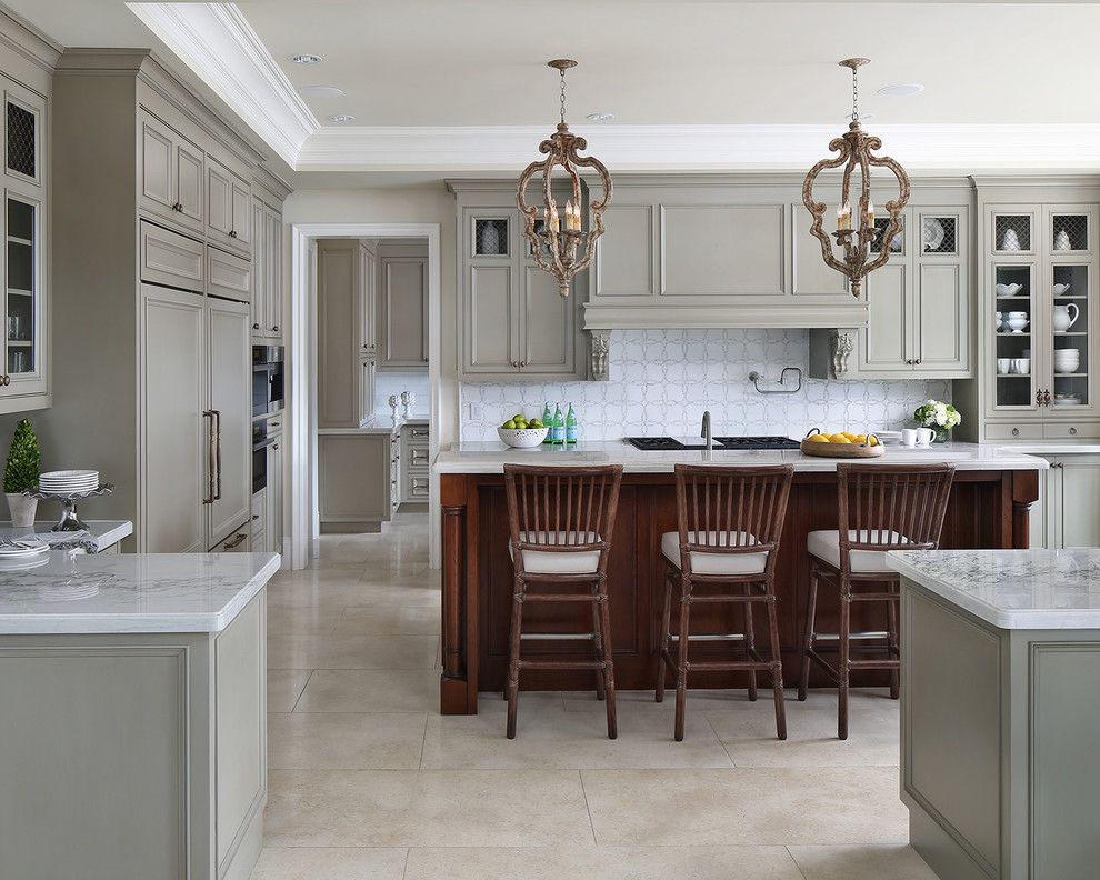 Design ideas for a traditional u-shaped open plan kitchen in San Francisco with recessed-panel cabinets, beige cabinets, marble benchtops, white splashback, panelled appliances, travertine floors, with island and beige floor.