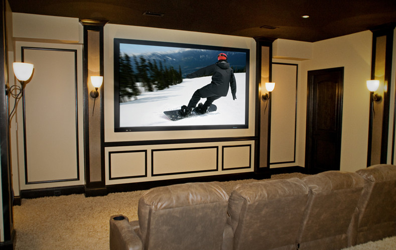 Photo of a large traditional enclosed home theatre in New York with white walls, carpet, a projector screen and white floor.