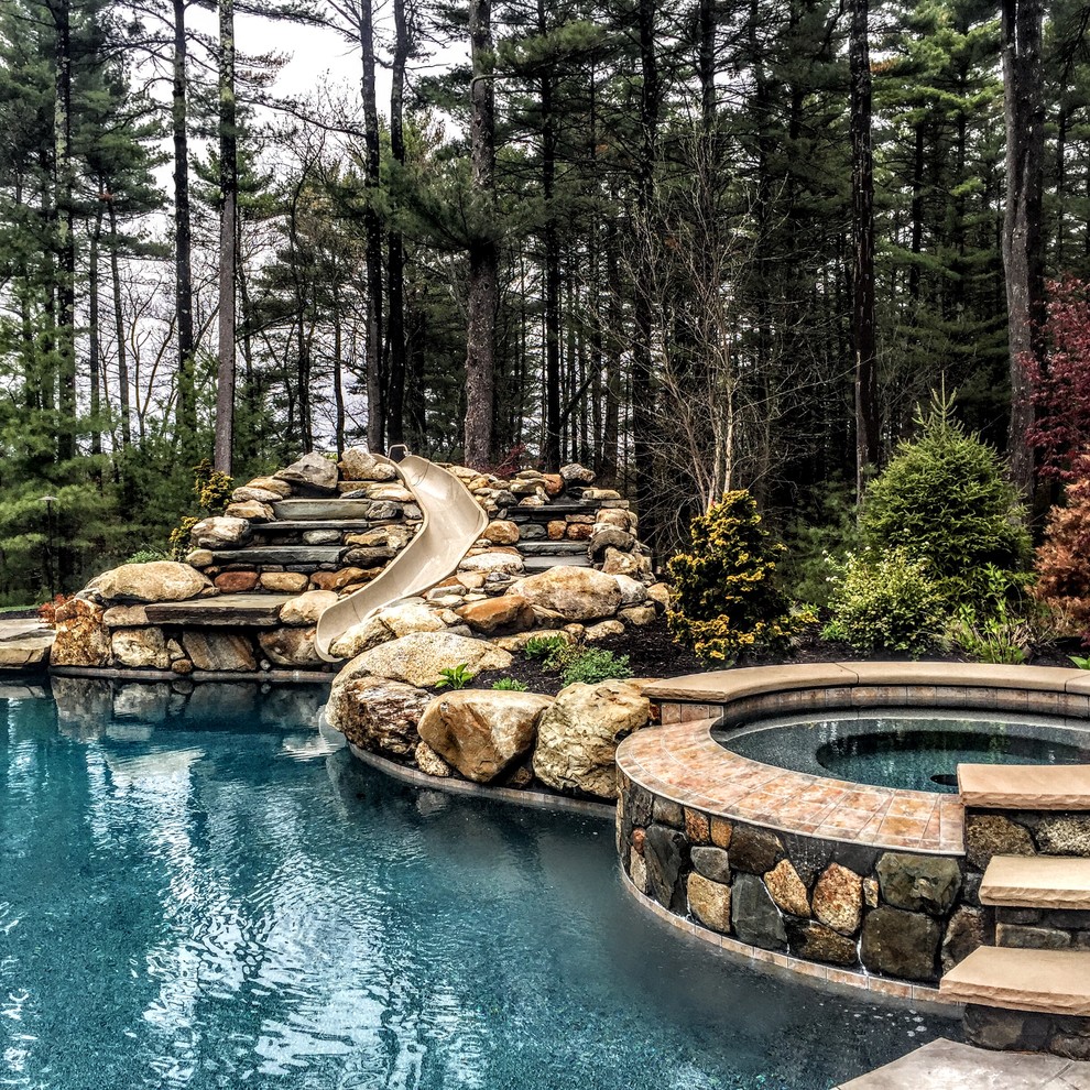 Inspiration for a mid-sized country backyard custom-shaped natural pool in Boston with a hot tub and stamped concrete.
