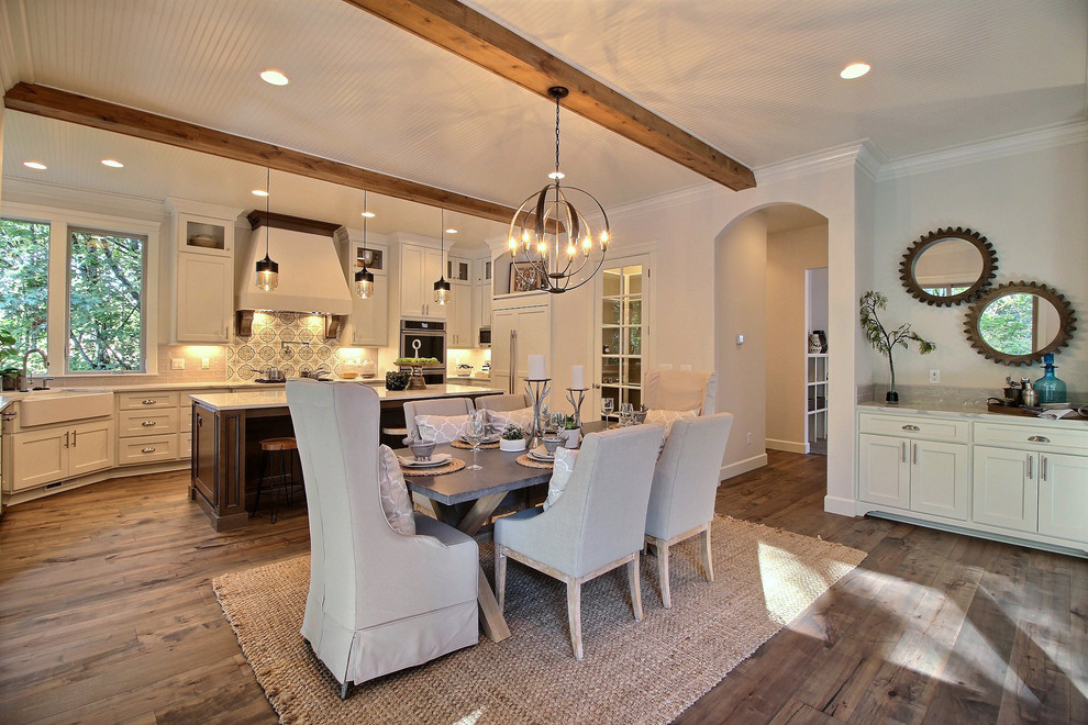 Photo of an expansive arts and crafts open plan dining in Portland with beige walls, medium hardwood floors, a standard fireplace, a brick fireplace surround and brown floor.