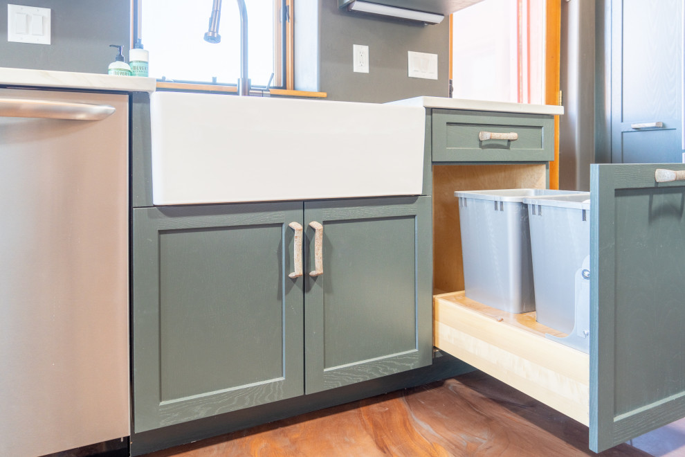 Example of a transitional concrete floor kitchen design with shaker cabinets, blue cabinets and stainless steel appliances