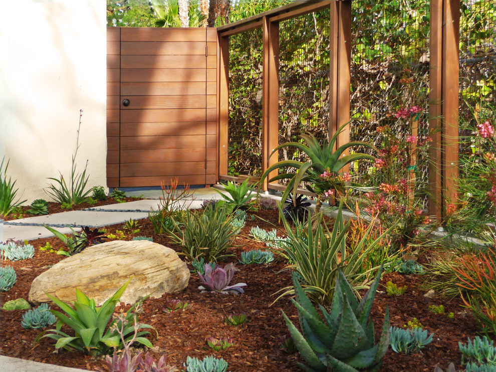 Inspiration for a large modern front yard full sun garden in Los Angeles with concrete pavers.